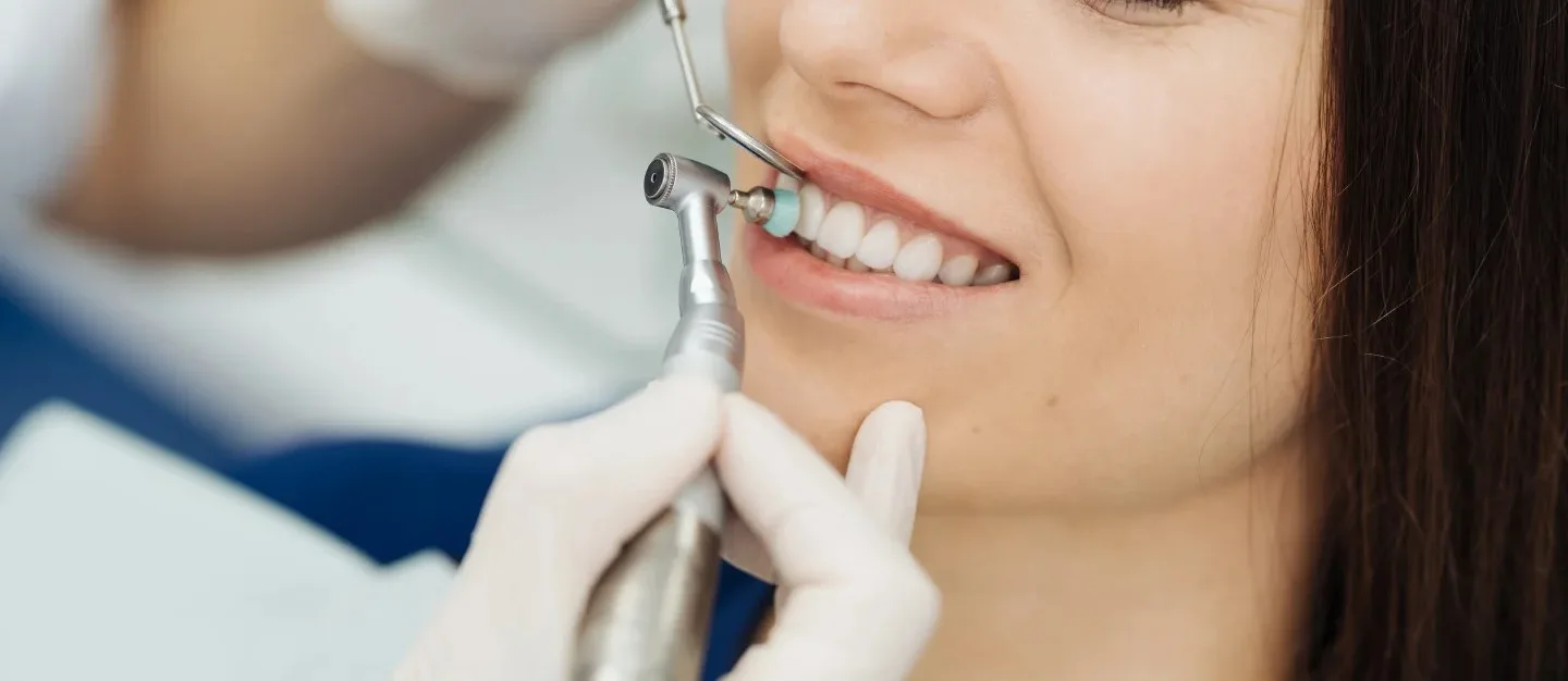 Smiling patient receiving a professional dental cleaning